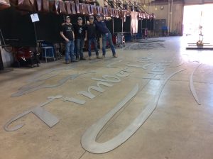 Four CLC welding students with their work for the sign.