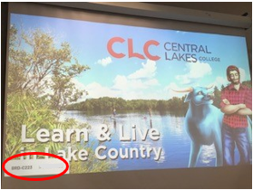 The image that appears on the projector screen prior to connecting to Airtame is a lake background with Paul Bunyan and Babe the Blue Ox. The IP address is displayed in the lower left corner of the screen. 