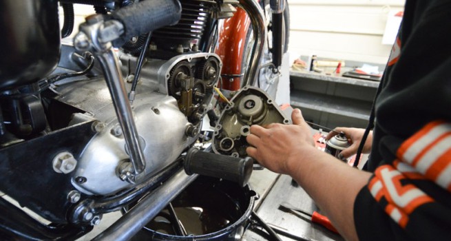 student working on motorcycle