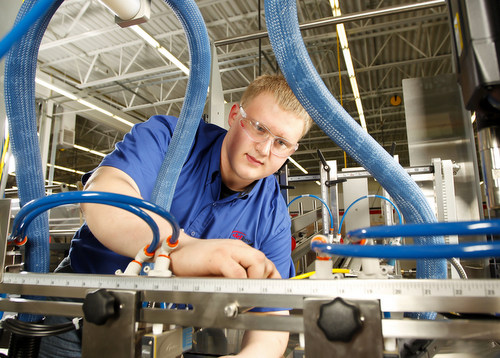 student looking at machinery