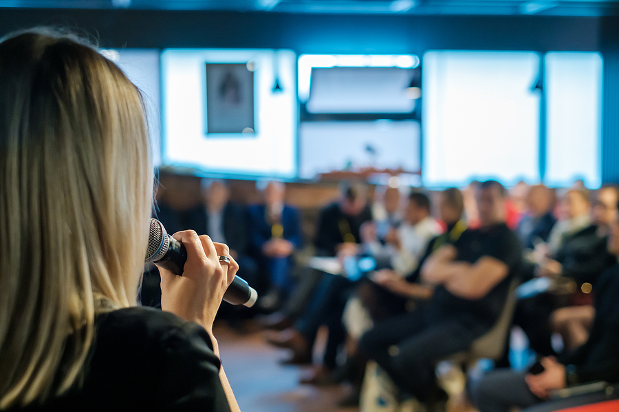 Female presenter speaks to audiences at workshop