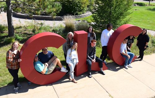 students outside with clc logo