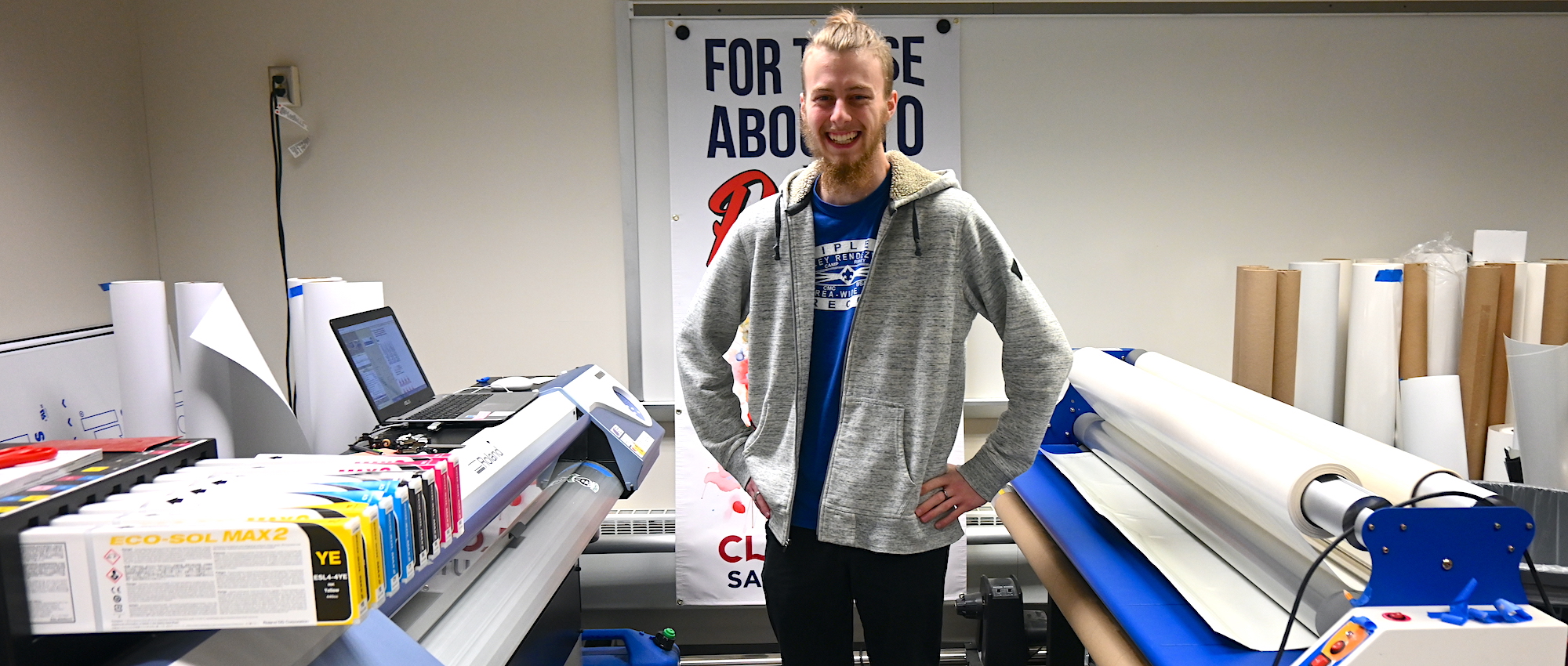 student standing with printers