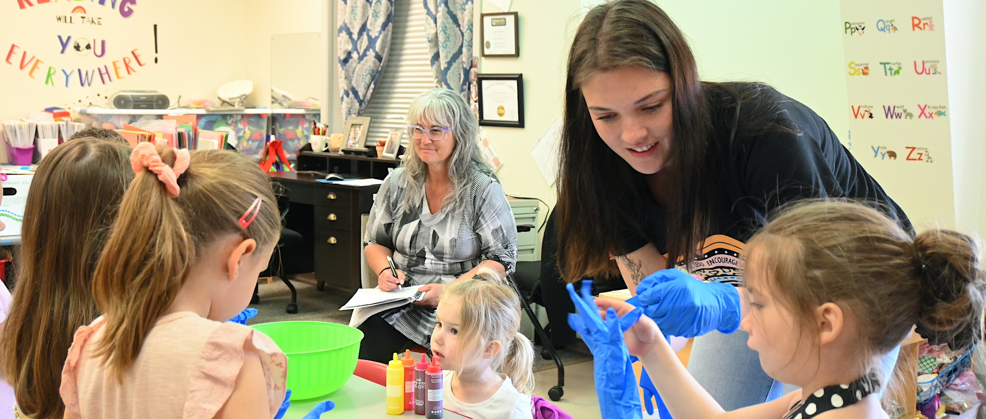Teacher with students making projects