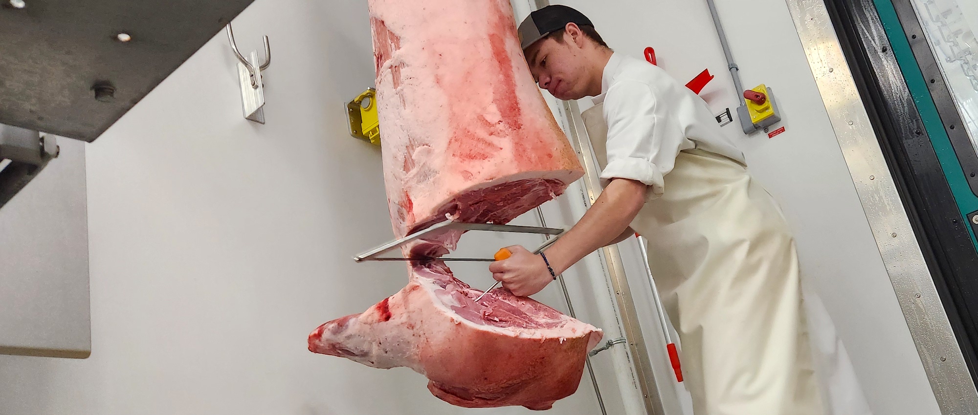 student cutting meat