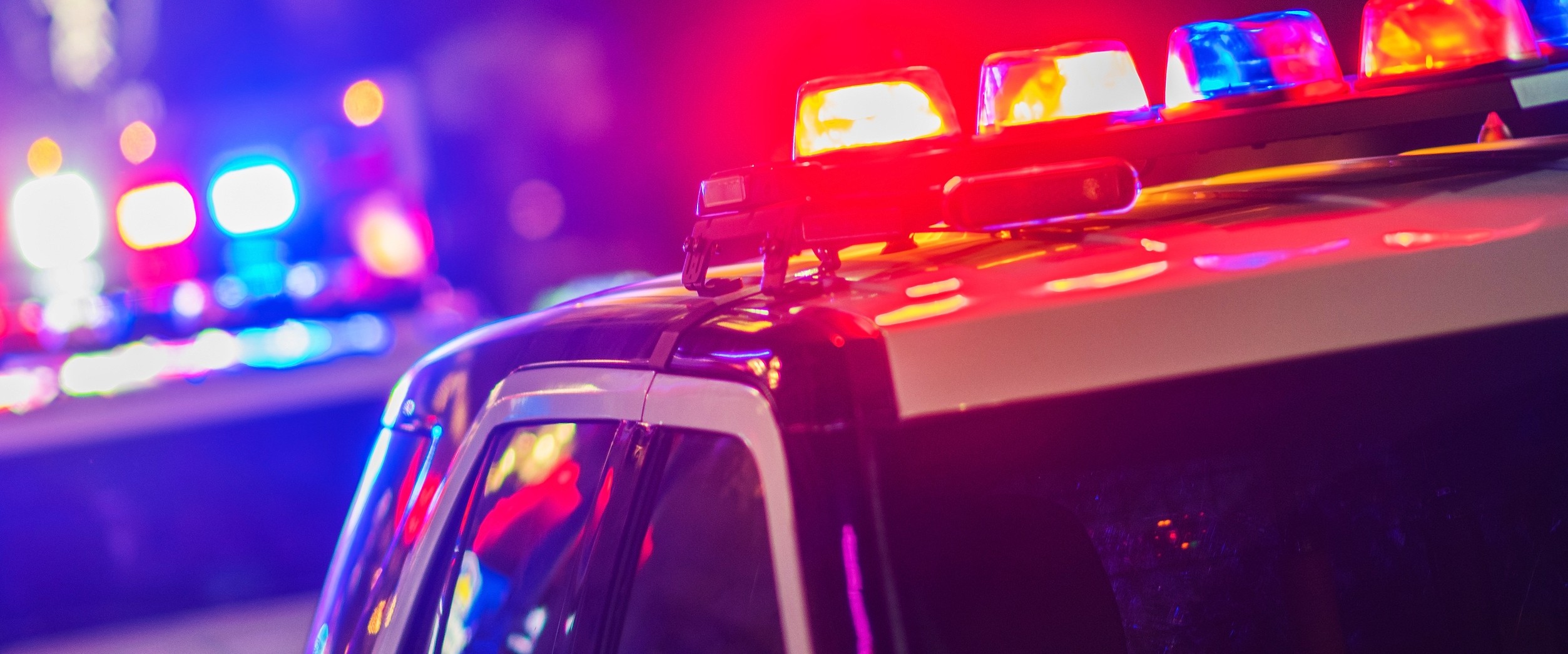 Night Time Police Violent Crime Intervention. Police Vehicles with Flashing Lights.